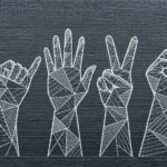 Geometric line art hand signs mural on dark brick wall